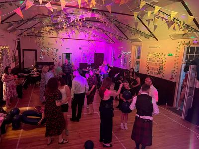 A pink-lit wedding barn alive with dancing
