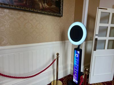 The selfie pod set up against an elegant papered wall